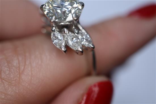 An 18ct white metal and single stone diamond ring, with marquise cut diamond set shoulders, size H/I.